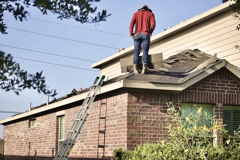 Professional roofer working on a residential roof in Merry Hills